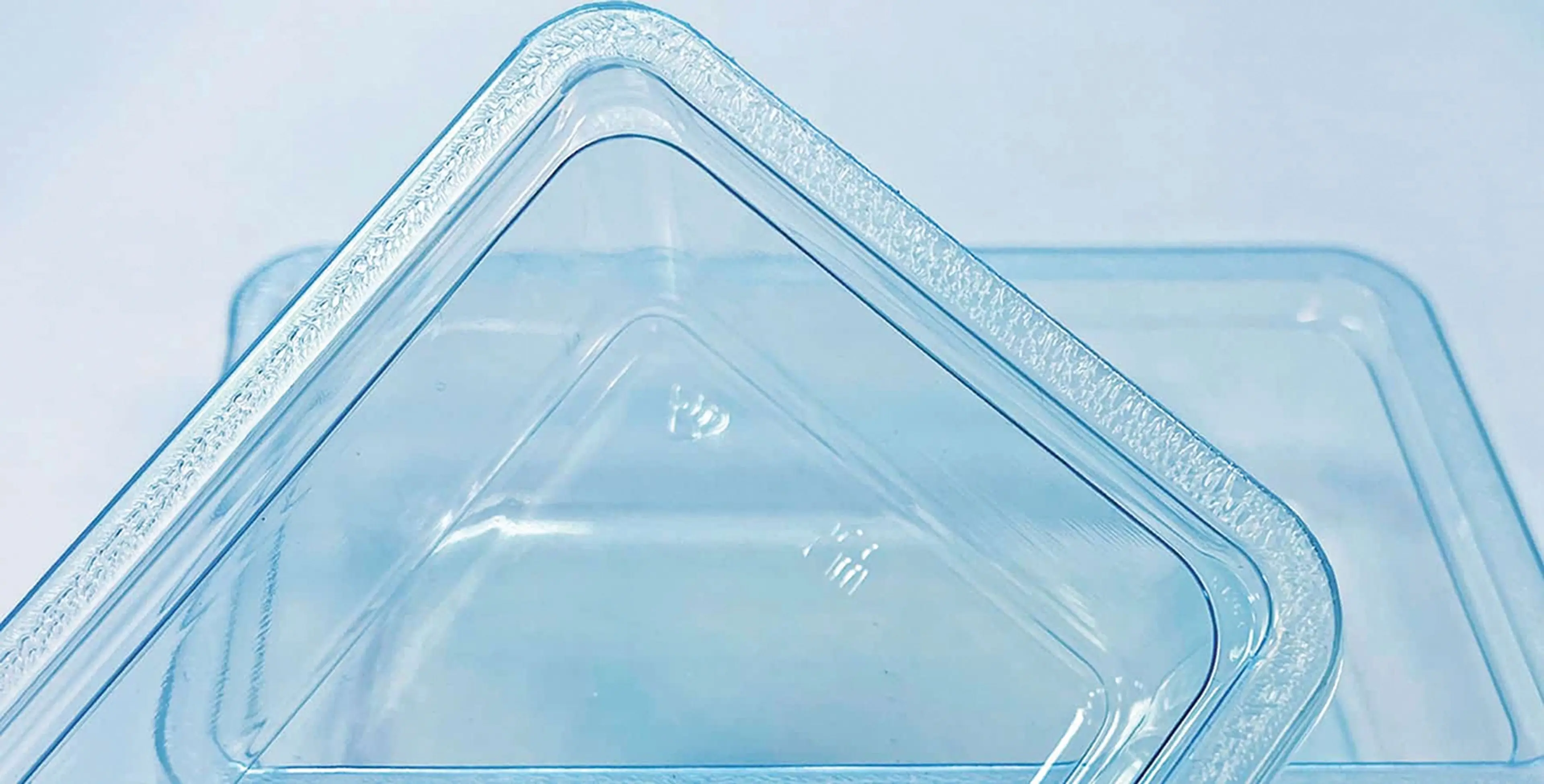 Two plastic meat trays