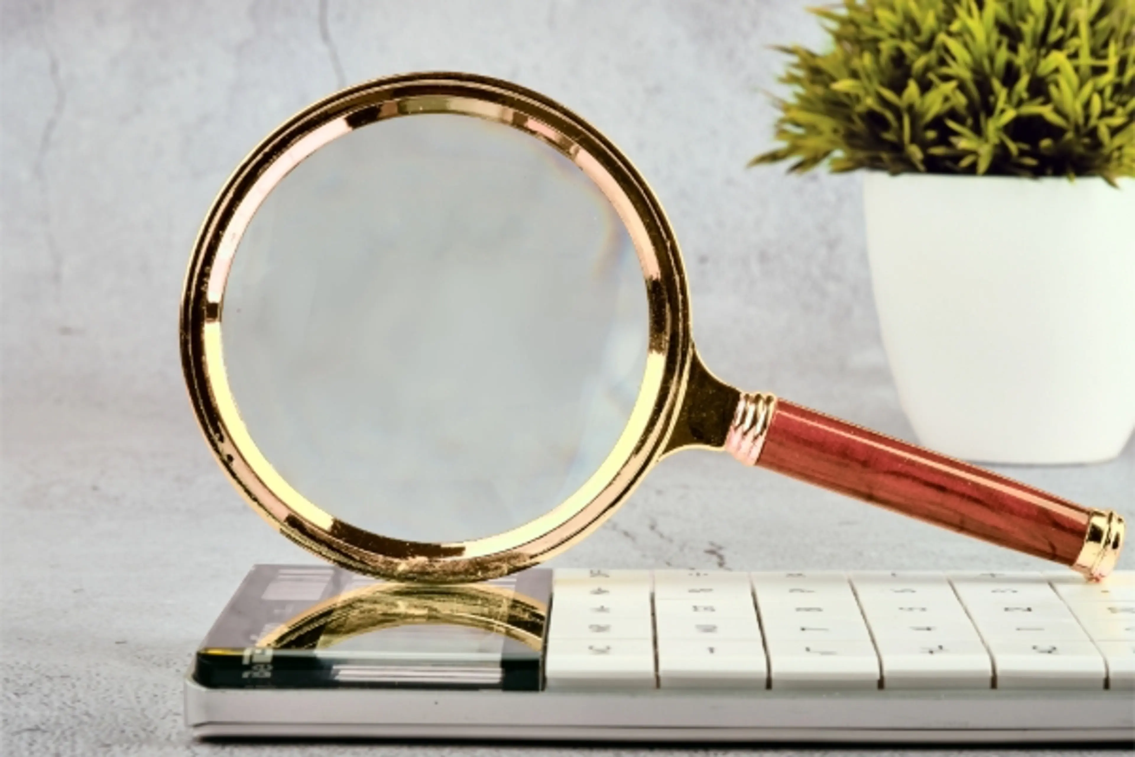 Magnifying glass on top of calculator
