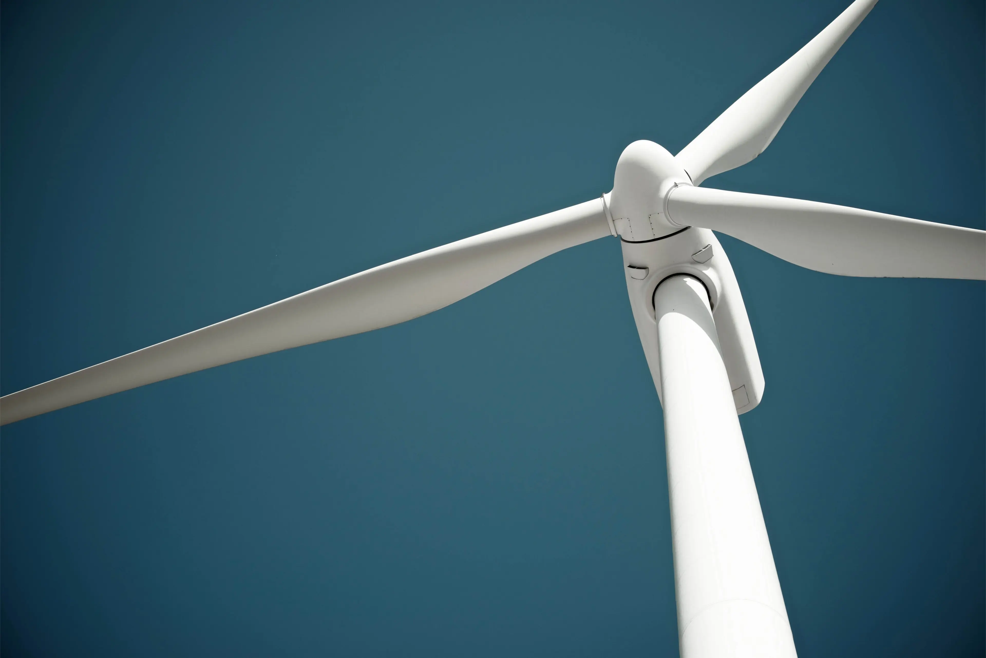 Close up of wind turbine blade with blue sky
