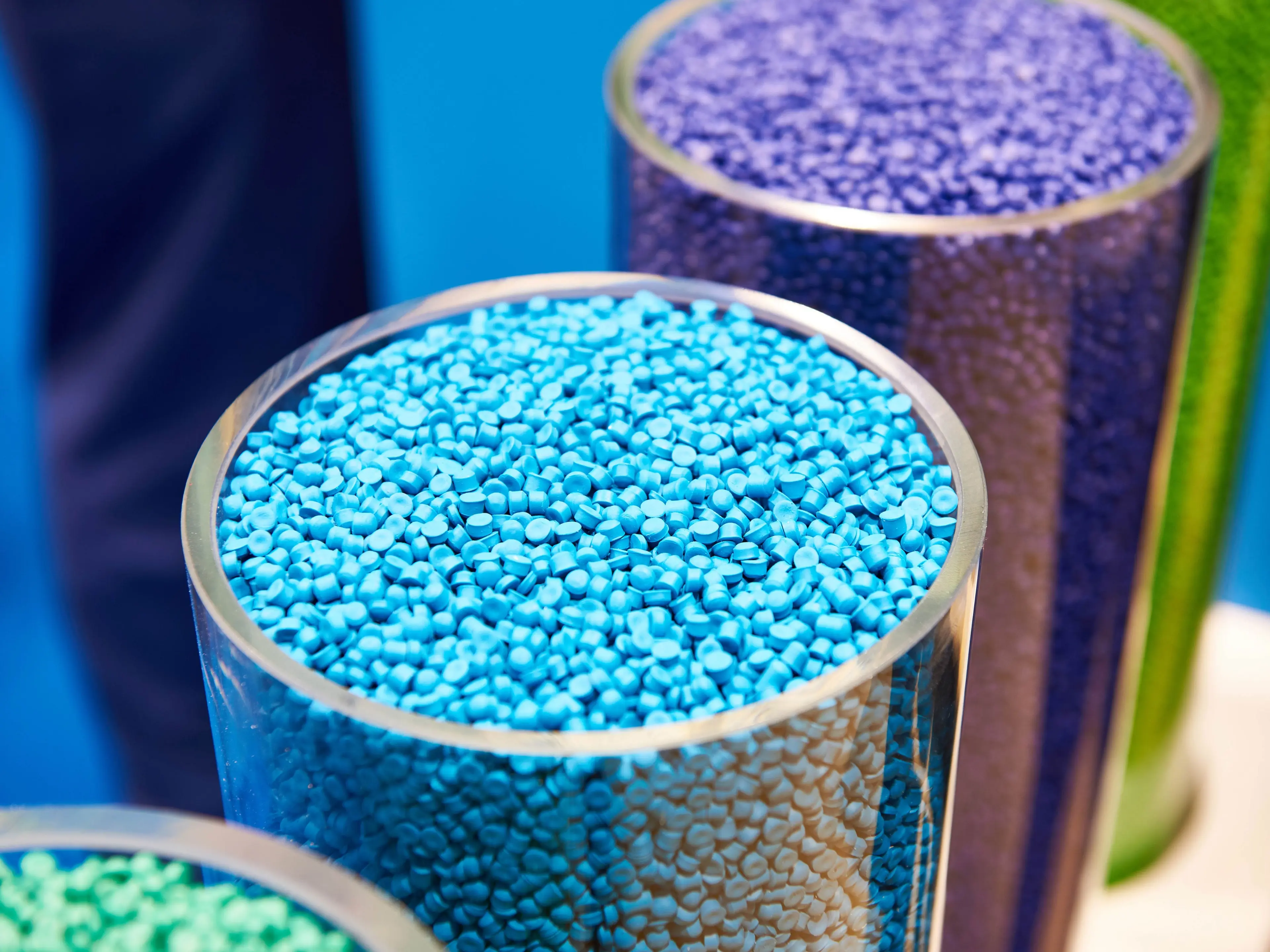 Glass jar of blue plastic pellets