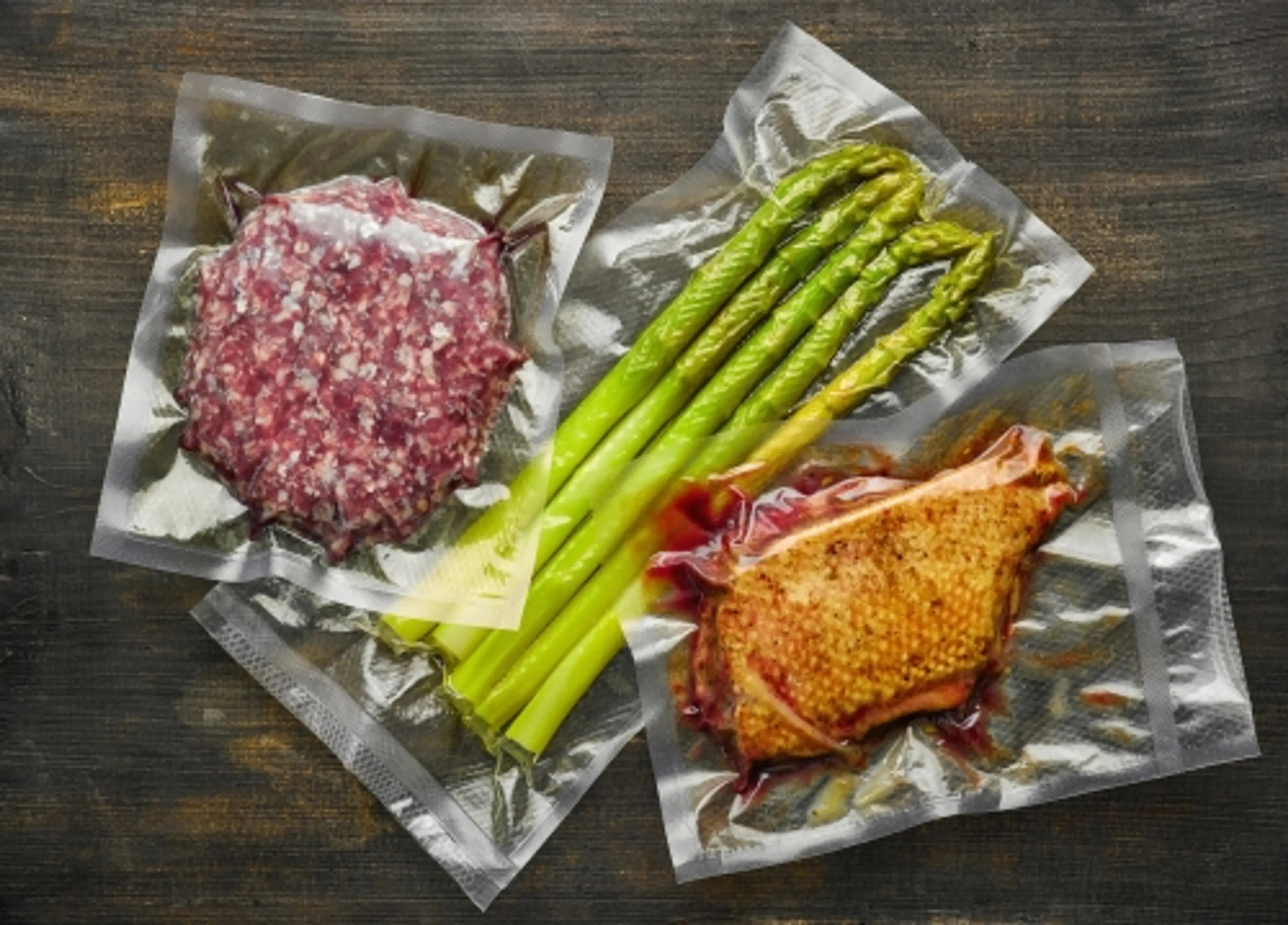 a photo of plastic packaged meat and vegetables