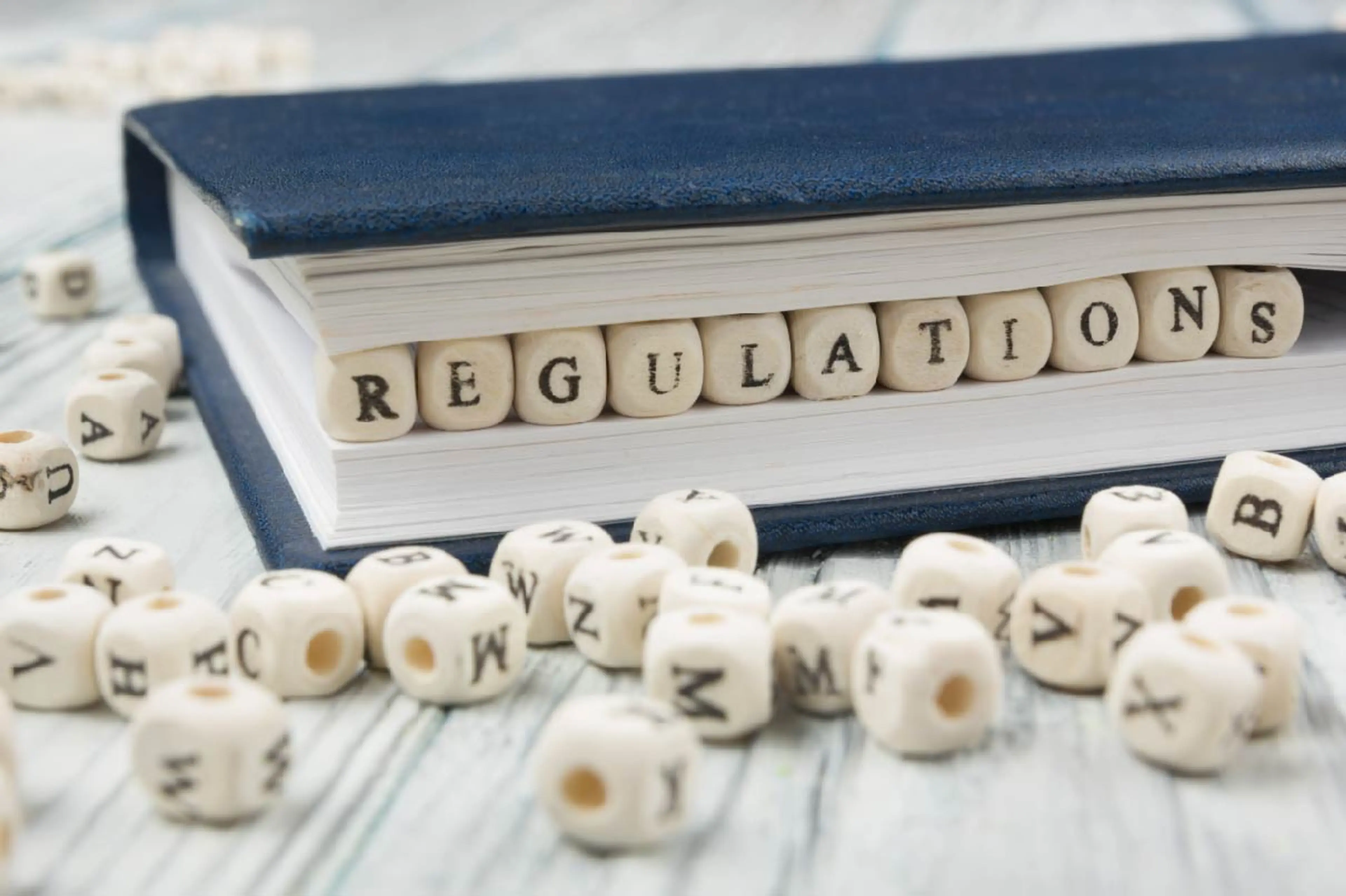 Image of plastic beads selling regulations tucked in a book