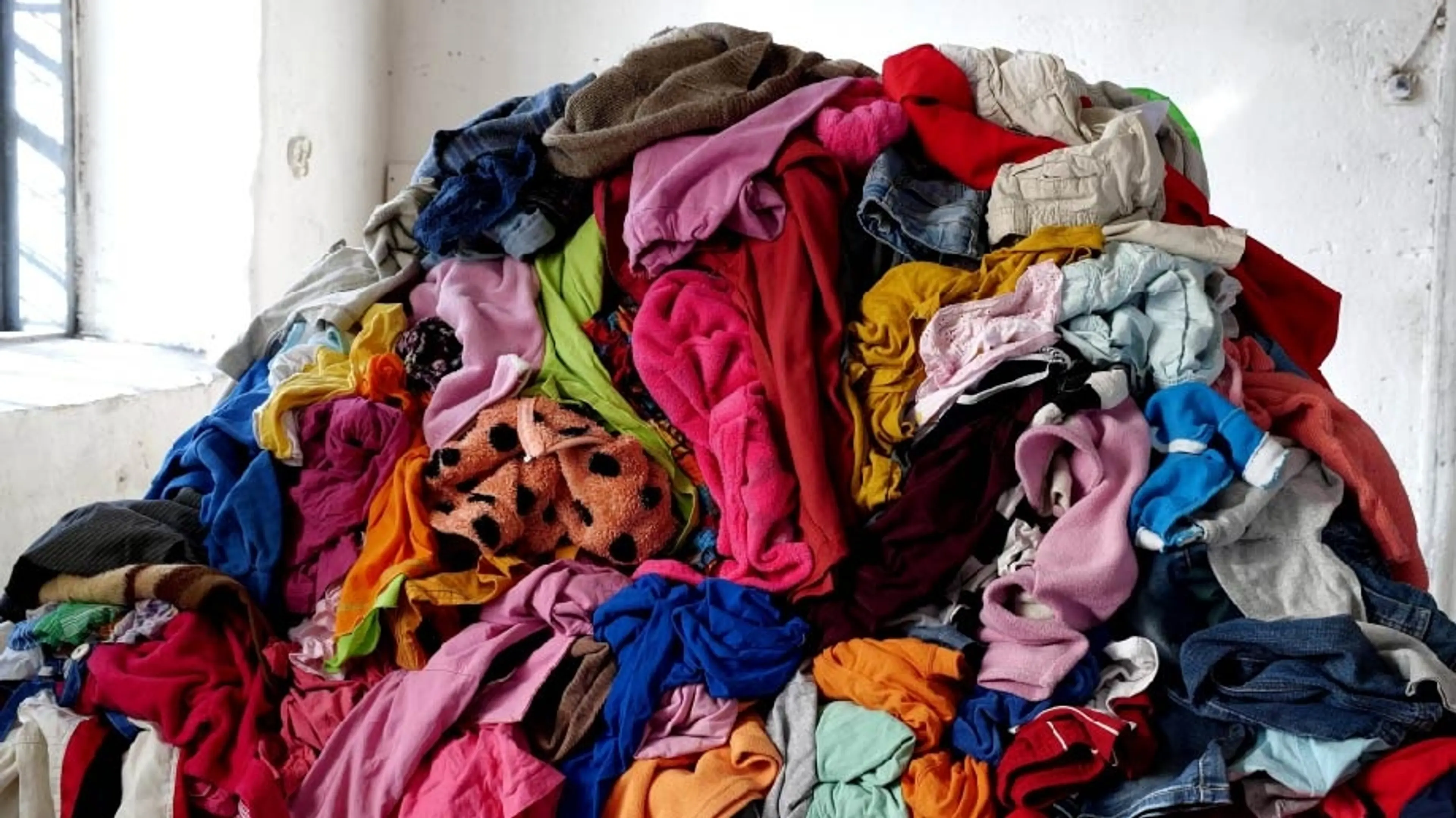 A pile of colourful recycled clothes