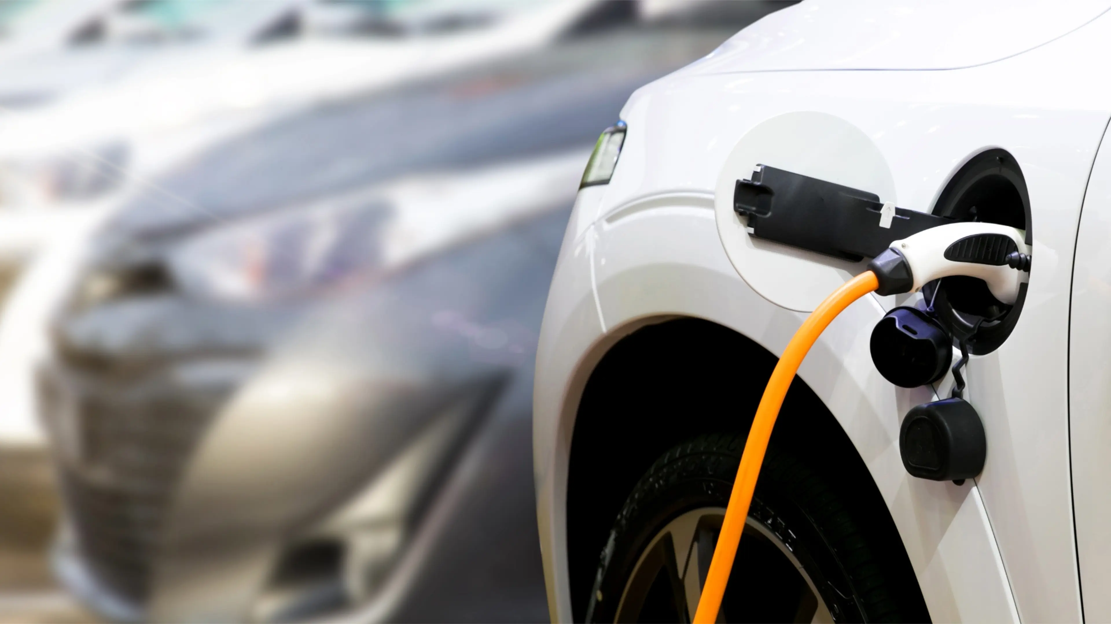 white electric car being charged